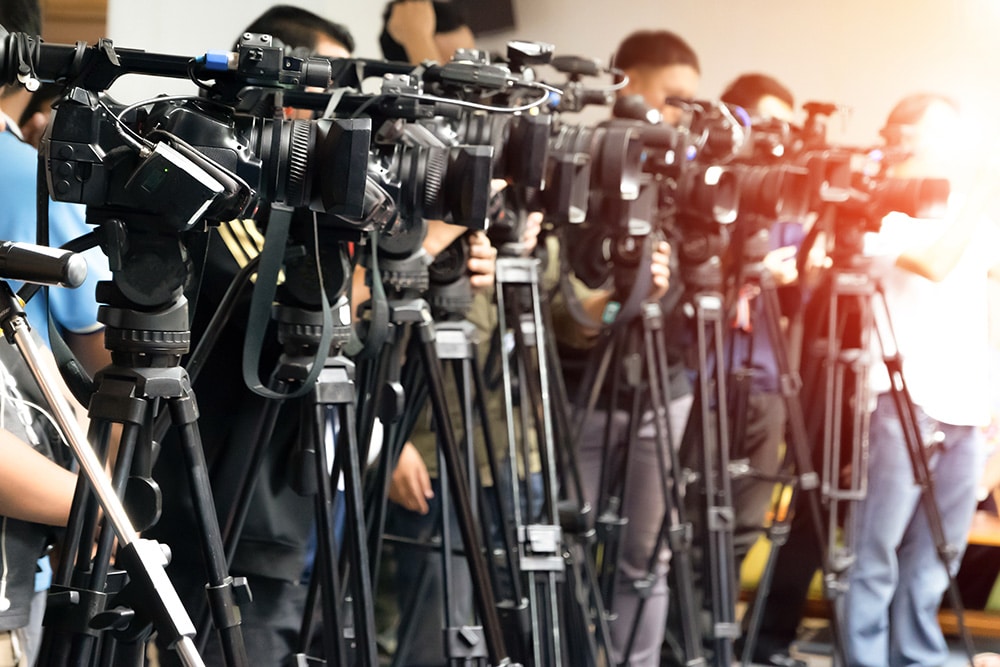 Cameras lined up at a press conference.